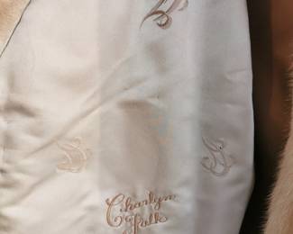 Lining detail showing embroidered name on the interior of lovely vintage oversized sand colored fur jacket featuring wide sleeves and a zip closure by Keim Furs Chicago Illinois