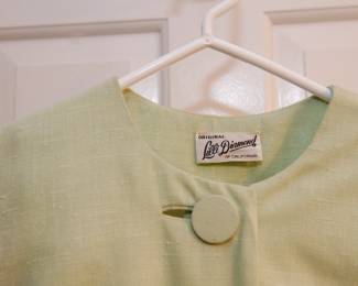 Tag detail of vintage lime green Lillie Diamond of California dress with matching coat featuring three fabric buttons and a bow
