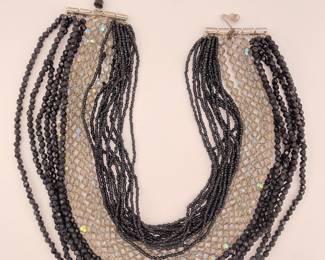 Multi layered black and clear bead necklace with a silver clasp
