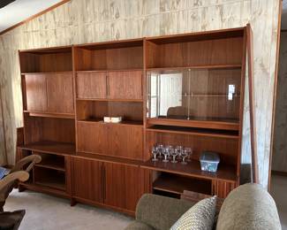 Absolutely fabulous room divider or wall unit in teak by and Excellent Furniture made in Germany in the early 1960’s. Very collectible and in excellent shape. and it has finished outback panels, so you can use it as a room divider in between rooms, like living and dining. Completely comes apart and is easy to put together in any combination that you need, shelves are all adjustable. This unit is the top of the line EX 600 with all the bells and whistles, glass doors, secretary or wet bar, sliding doors. Incredibly well made