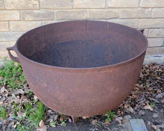 Several large outdoor cast iron cauldrons
