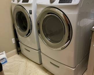 LG Smart washer and dryer on pedestal drawers.