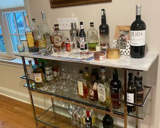 Serve up style along with your favorite libations with this bar, which features a chrome finish, glass shelves and faux marble tops. 15" L x 52" W x 35.25" H