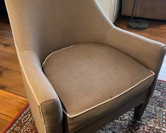 Dark gray Piper Accent Chairs with eye-catching piping.  This chair features a slanted back, slim sloping arms, a boxy seat cushion and dark tapered wooden legs.  35" W x 30" L