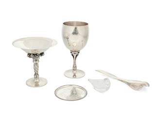 38
Georg Jensen (1866-1935)
A group of sterling silver table items, mid-20th century
Each marked for Georg Jensen and sterling; bird marked: Allan Scharff / 485
Comprising a tazza compote with grape motif 263A (5" H x 5" Dia.), an "Acorn" hammered silver goblet 532C (6.75" H x 3.125" Dia.), a small dish with chased grape vine motif 51B (3.625" Dia.), and a glass and sterling letter opener 485 designed by Allan Scharff (b. 1945) (2" H x 7.5" W x 1.5" D)
4 pieces
20 oz. troy approximately
Estimate: $1,000 - $1,500