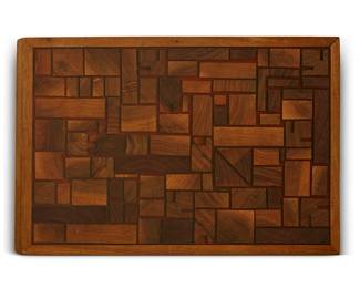 189
Evert Sodergren (1920-2013)
A wood cheese board/cutting board, mid-20th century
Burn marked to applied wood plaque to underside: södergren
The board with assembled rectilinear wood blocks of various shapes and sizes, the gaps between each filled by resin to achieve a smooth surface, with plastic feet to underside
14.5" L x 10" W x 1" D
Estimate: $400 - $600