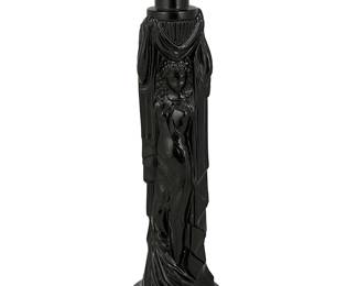 242
Circa 1930s; Verdun, France
A Maurice Model Figural Perfume Bottle
Marked to underside: M Model / France
The French Art Deco black molded glass bottle in the shape of a woman draped in loose cloth and holding an urn overhead
9.25" H x 2.325" Dia.
Estimate: $400 - $600