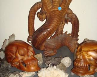 Balinese carved mahogany skulls & 3 headed dragon amoungsts amythest & quartz crystals .