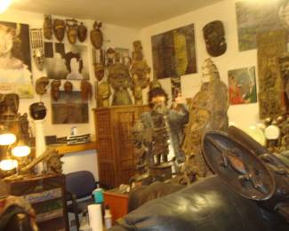 Room full of African art & quartz specimens Large Grassland giant mask , Cameroon W.African on Modern Italian black leather couch , Dogon cabinet  from Mali W. Africa