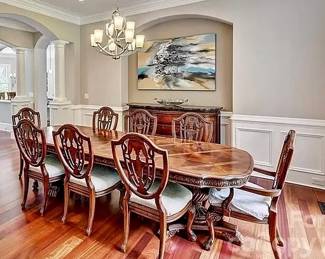 Dining table with 8 chairs (artwork not for sale). 9’2” long x 43” wide. Measured with two leafs in. Each leaf is 18” long.
