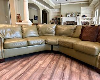 Olive colored curved shape leather sofa. Each ‘C’ shaped section measures 7’6”