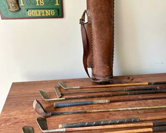 Antique wooden shaft golf clubs and leather bag