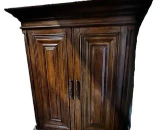 $1200 USD      Tommy Bahama Wood Armoire Wardrobe Entertainment Center WDI224-32     Transform your bedroom into a luxurious oasis with the Tommy Bahama Armoire Wardrobe Entertainment Center. This sleek and stylish piece not only offers ample storage space for your clothing and accessories, but also features built-in entertainment options. Enjoy the convenience and elegance of this multifunctional wardrobe.

Dimensions: 60  x 24 x 69.5H in  |  Interior TV space 50 x 39H in

Condition: New

Location: Local pick up Portland, OR 97224.  Shipper suggestions available upon request.     https://goodbyhello.com/products/copy-of-bernhard-armoire-entertainment-center-wardrobe-wdi224-31?_pos=12&_sid=f1836dac0&_ss=r