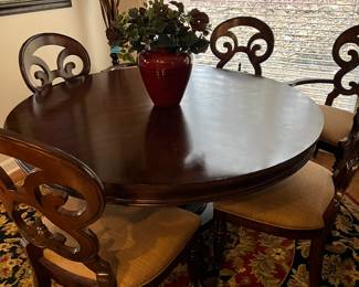 Cherry dining table with 6 chairs and a leaf