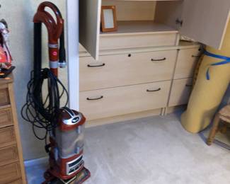 Blond cabinet/dresser, matches desks and file cabinets in other bedroom for a whole suite