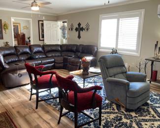 Sectional couch.  Recliner, area rug, two armchairs they think came from the Peabody Hotel, Lots of Home decor and art, metal coffee table