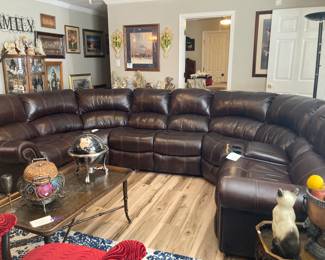 Leather sectional couch reclining on each end. 