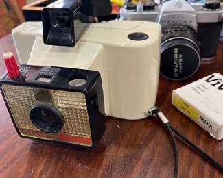 Vintage Polaroid camera and Pentax.  