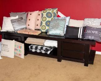 Assortment of linens and decorative pillows