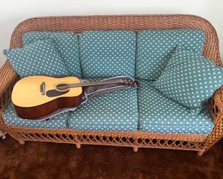 Wicker sofa and guitar