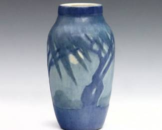 An early 20th century Newcomb College Art Pottery vase decorated by Sadie Irvine.  Baluster form with Blue landscape decoration depicting trees with blowing Spanish Moss.  Impressed maker's mark, "SV86" date mark (1931), and artist's initials.  Minor crazing and surface wear.  5 1/2" high.  
