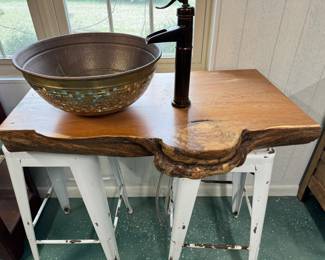 Live-edge cypress counter with copper sink bowl and pump-style faucet (stools only holding up the piece, not attached)
250.00