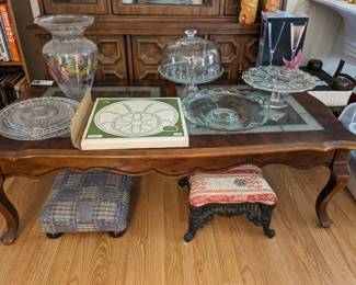 Coffee table with pie plates and antique footstools