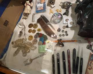 Lots of odd coins and tokens, fancy pens (some sweet Parkers) paperweights, etc. 