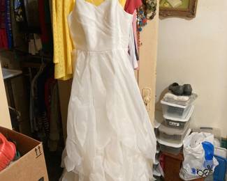 A beautiful white gown is for sale as well. It’s striking.