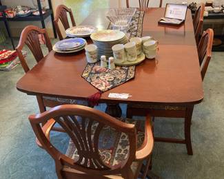 Here’s a mahogany dining room table with six chairs.