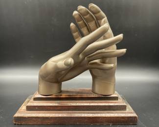 Plastic Hand Sculpture on Wooden Base