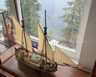 multiple wooden ships in glass museum displays