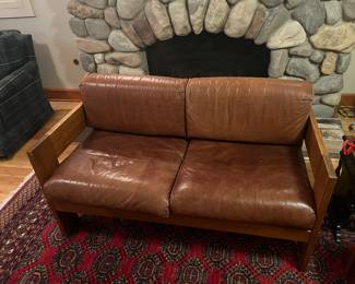 $220 Three piece set includes this loveseat and matching chair shown in the next photo. Leather and wood framed loveseat. 50.5"w x 28"d x 30"h. Two straps underneath need reinforcing. Next photo shows issue.