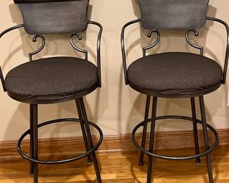 Pair of iron bar stools with upholstered padded seats
