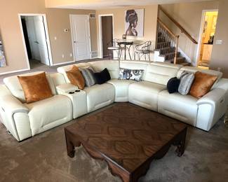 Beautiful cream leather sectional with two electric recliner seats. Hardly ever sat on! Like new!
