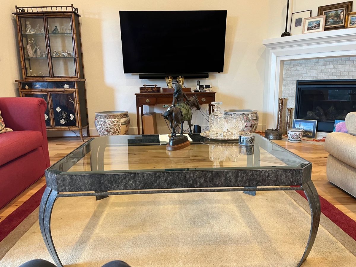 One of three recent smart LG TVs. Note the interesting antique Victorian bamboo and black display piece in back left corner.
