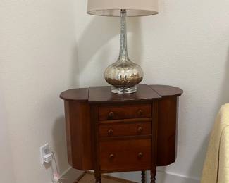 Sewing stand used as a bedside table.