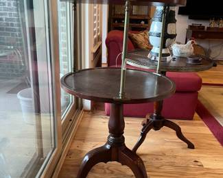 View of one tripod table that is an adjustable two-tier for serving