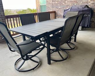 Rectangular table with six mesh swivel/rocker chairs.