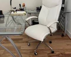 Elegant white office chair and glass desk