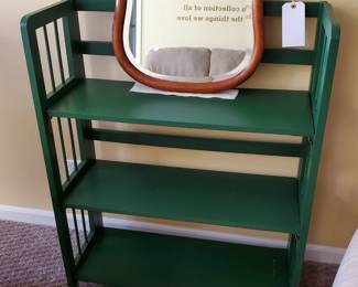 Mirror resting on folding shelf unit