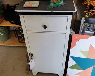 Cute little white metal cabinet