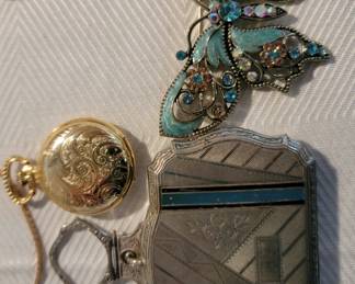 Vintage makeup compacts, brooches and pocket watch.