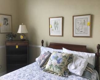 Double bed, framed advertisements, wood bookcase with 1 drawer