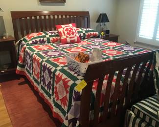Probably Ethan Allen sleigh bed, handmade quilt, etc.