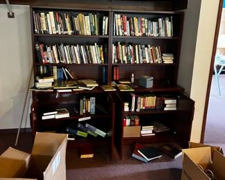 Bookshelves and lots of religious themed books 