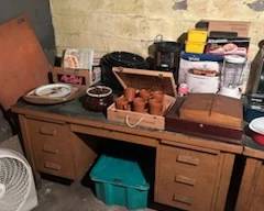 Old metal desk full of household