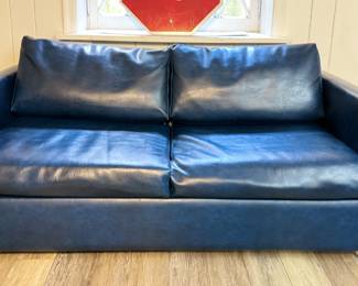 Blue Vegan Leather Sleeper Sofa. Measures 64" W x 33" D.
