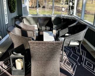 Outdoor Wicker Patio Set includes: Set of 4 Chairs with Striped Cushions and 2 Additional Chairs with the White Cushions. White Bench Style Table