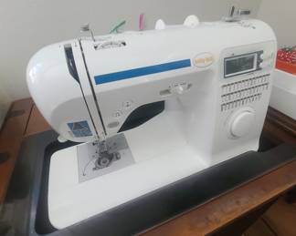 Baby Lock Grace model sewing machine in a cabinet